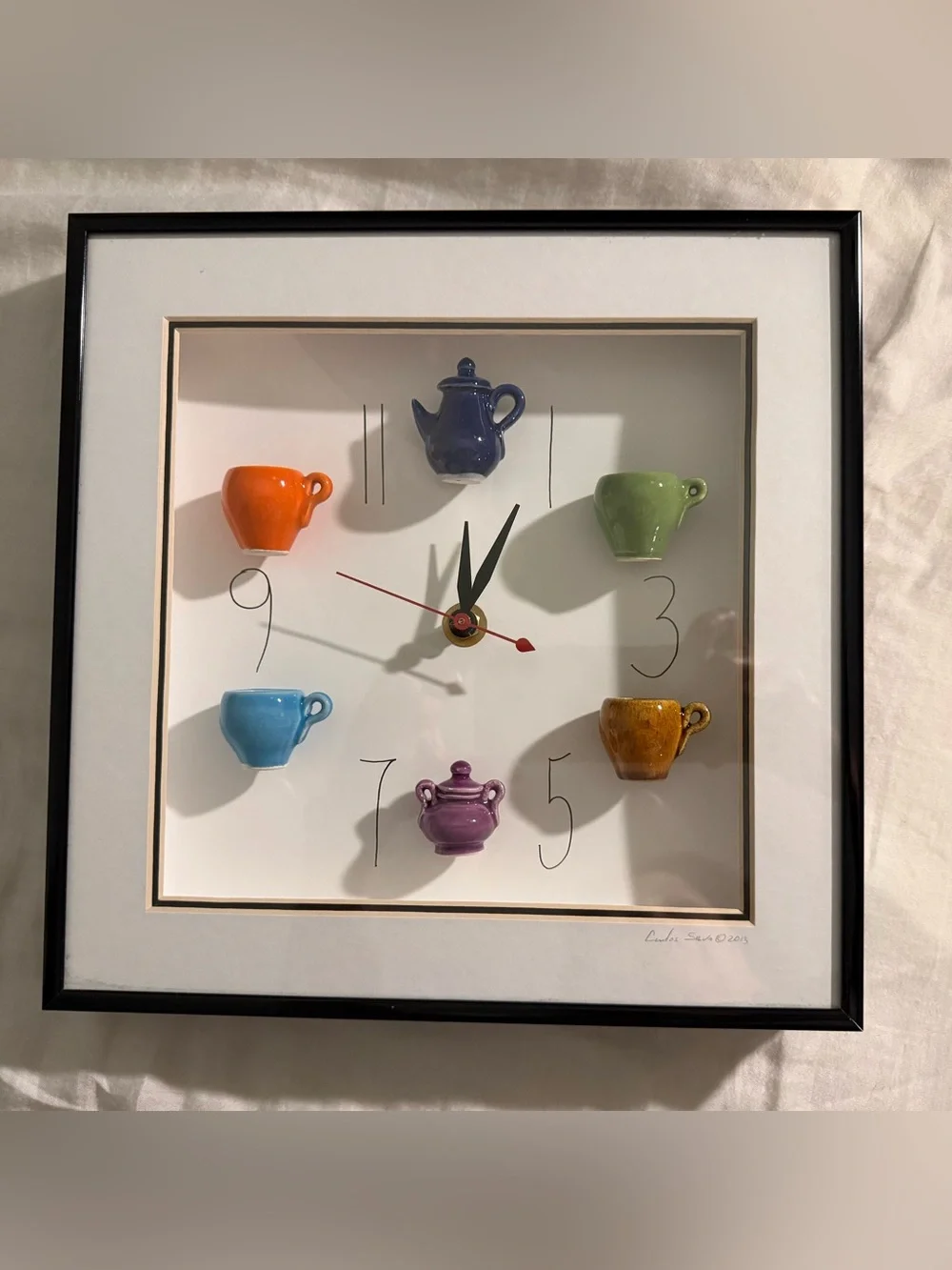This 10x10 inch shadowbox wall clock, signed by artist Carlos Silva of Centuries